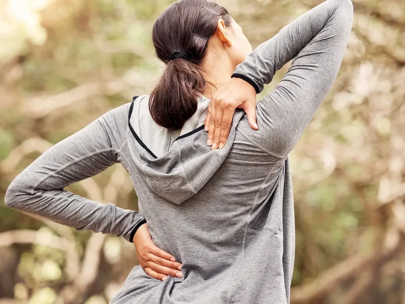 Physical therapist assessing a patient's low back movement and mobility