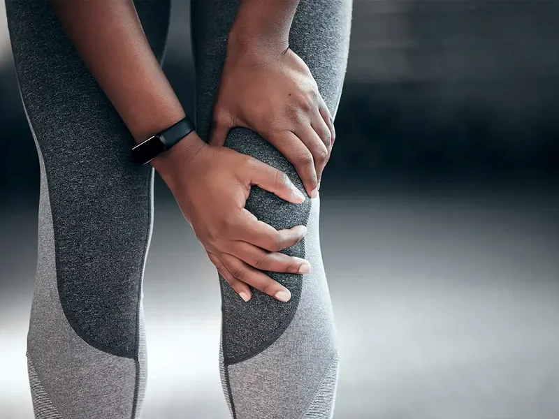 Physical therapist assessing a patient's hip and knee movement and mobility