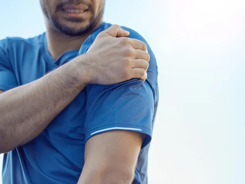 Physical therapist assessing a patient's shoulder movement and mobility