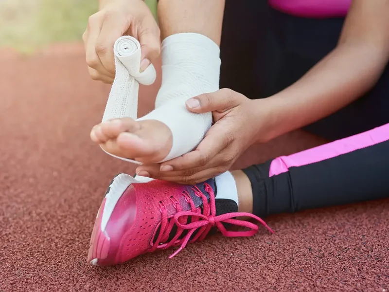Physical therapist testing an athlete's movement and strength during a return to sport assessment