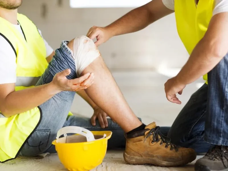 Physical therapist evaluating a patient's lifting mechanics after a work injury
